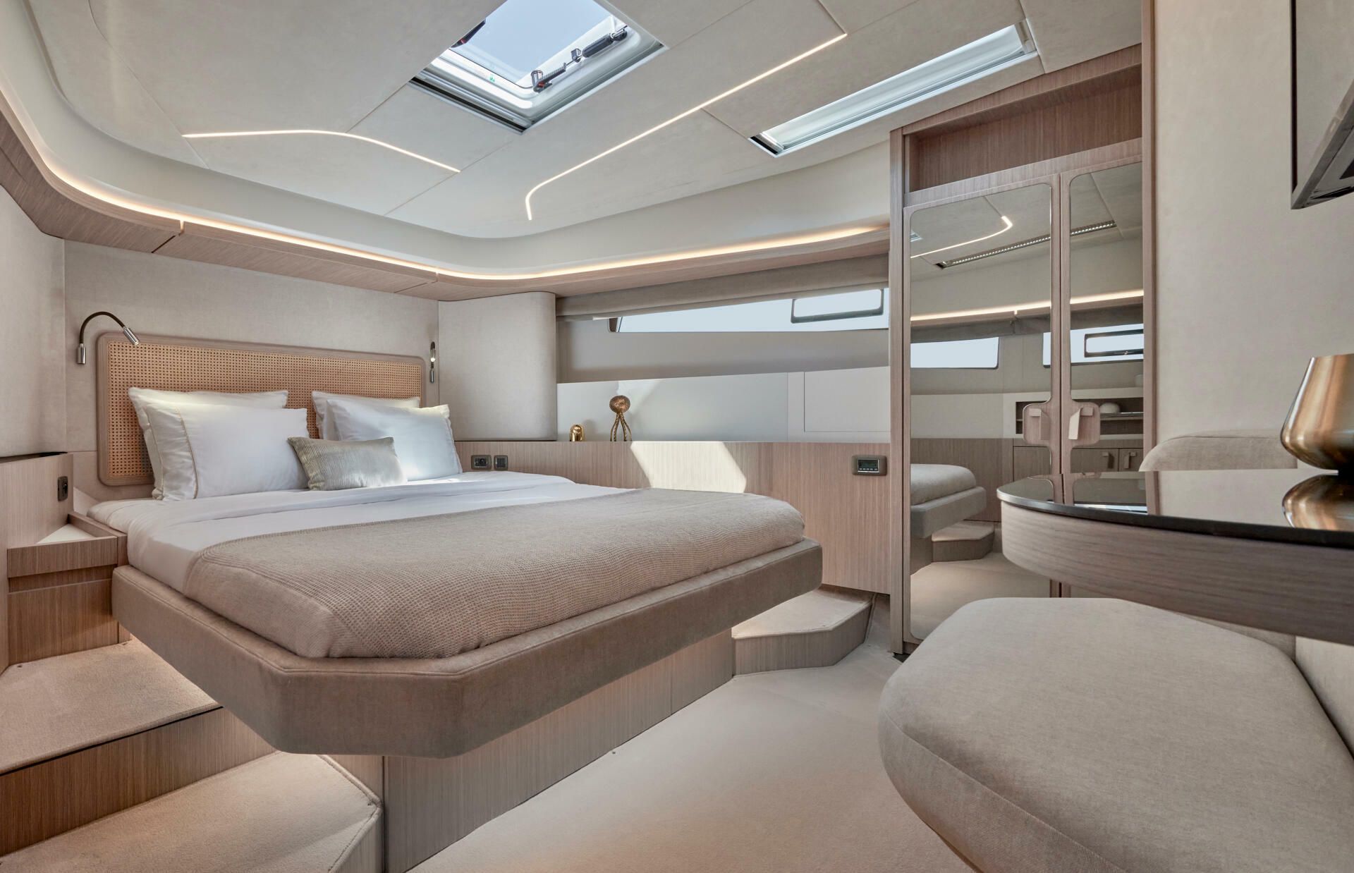 Jeanneau-Yacht-Prestige-F4.9-marseille-yacht-mediterranee00013 a bedroom with a bed and a mirror on yacht Prestige F4.9 Marseille