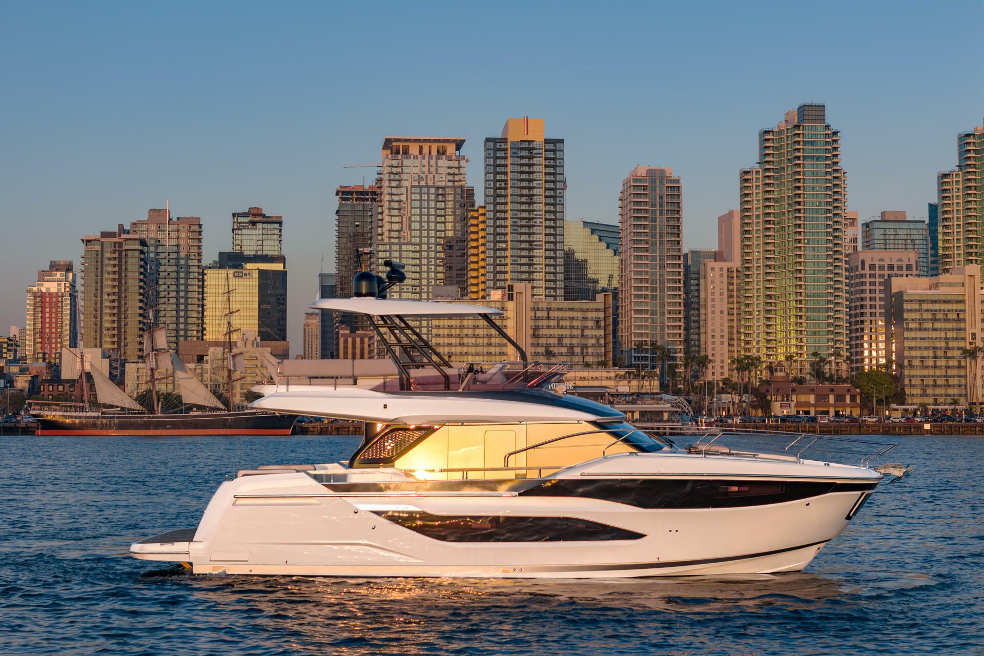 Jeanneau-Yacht-Prestige-F4.9-marseille-yacht-mediterranee00030 a white boat on water with a city in the background yacht Prestige F4.9 Marseille